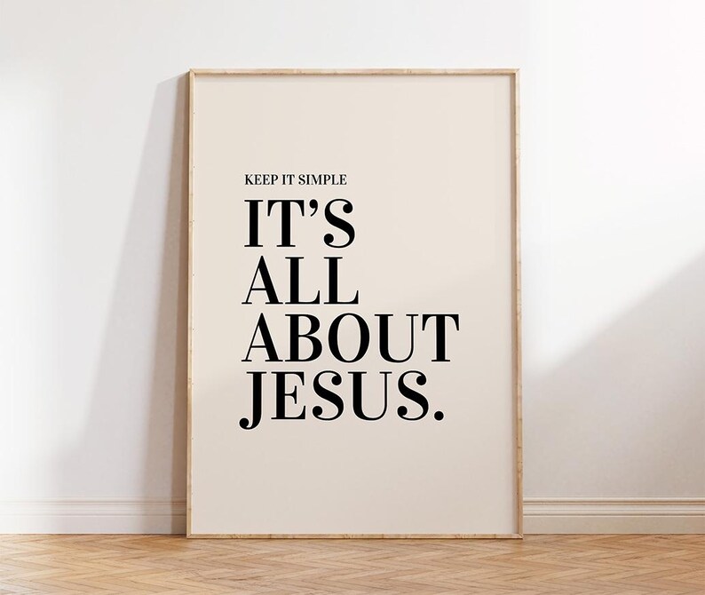 K&ouml;nnte beinhalten: Ein gerahmter Druck mit dem Text "KEEP IT SIMPLE IT'S ALL ABOUT JESUS." Der Text ist in einer fetten, schwarzen Serifenschrift auf cremefarbenem Hintergrund. Der Rahmen hat eine helle Holzfarbe.