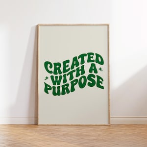 May include: A framed print with a white background and green text that reads "CREATED WITH A PURPOSE".