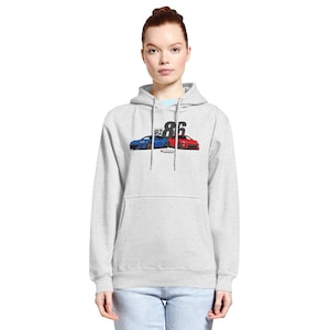 May include: Light gray hoodie with a front graphic featuring a blue and red sports car design, the number "86", and the text "BRZ". The hoodie has a kangaroo pocket and a drawstring hood.