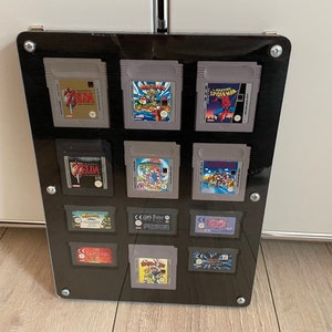 プレキシガラス保護付きの 7 個のゲームボーイ CLASSIC および 5 個の ADVANCE モジュールのコレクター フレーム