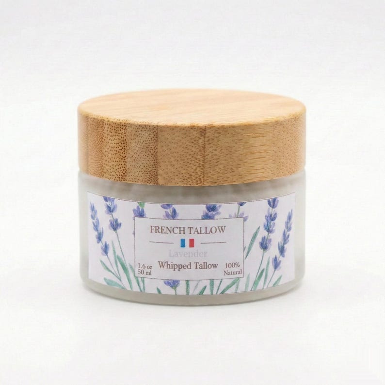 A closed frosted glass jar of French Tallow Lavender Whipped Tallow with a bamboo lid, centered against a plain white background.