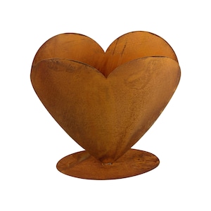 May include: A rusty metal heart-shaped planter with a round base. The planter is made of metal and has a rustic, weathered look.
