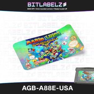 May include: A sticker for a Game Boy Advance game cartridge featuring Mario and Luigi from the game "Mario & Luigi: Superstar Saga". The sticker is printed on a clear, iridescent background with a blue, green, and purple color scheme. The sticker is designed to be peeled off and applied to a Game Boy Advance cartridge.