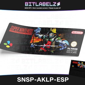 Op de afbeelding: Een zwart Super Nintendo Entertainment System-spelcartridge-etiket met een kleurrijk beeld van een personage uit de game Killer Instinct. Het etiket vermeldt "PAL VERSION SNSP-AKLP-ESP MADE IN JAPAN".