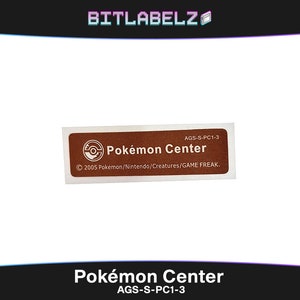 May include: A brown rectangular sticker with white text that reads "Pokémon Center" and "AGS-S-PC1-3". The sticker also features a white Poké Ball logo and the copyright information "© 2005 Pokémon/Nintendo/Creatures/GAME FREAK."