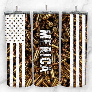 May include: Three stainless steel tumblers with a white and gold design. The tumblers feature an American flag design with a background of gold bullet casings. The middle tumbler has the word "MERICA" written vertically in black.