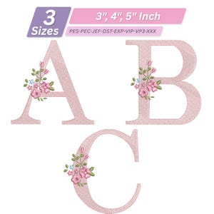 May include: Embroidered letters A, B, and C in a soft pink colour, decorated with floral accents. The letters are available in 7.6, 10.2, and 12.7 cm sizes. The design features delicate pink and blue flowers, ideal for crafts.