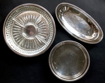 Set of vintage silver plated serving dishes.  Round tray with divided glass dish insert, small round tray, oval serving dish