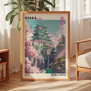 以下が含まれることがあります： 桜の花が咲く前景に日本の城が描かれた額装されたプリント。プリントのタイトルは「大阪城」で、「大阪日本」の文字が書かれている。