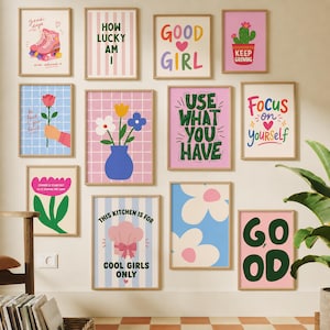 May include: A gallery wall featuring twelve rectangular framed art prints with colorful graphic designs, including illustrations of roller skates, flowers, a cactus, and various motivational text phrases like Good Girl and Focus on Yourself.