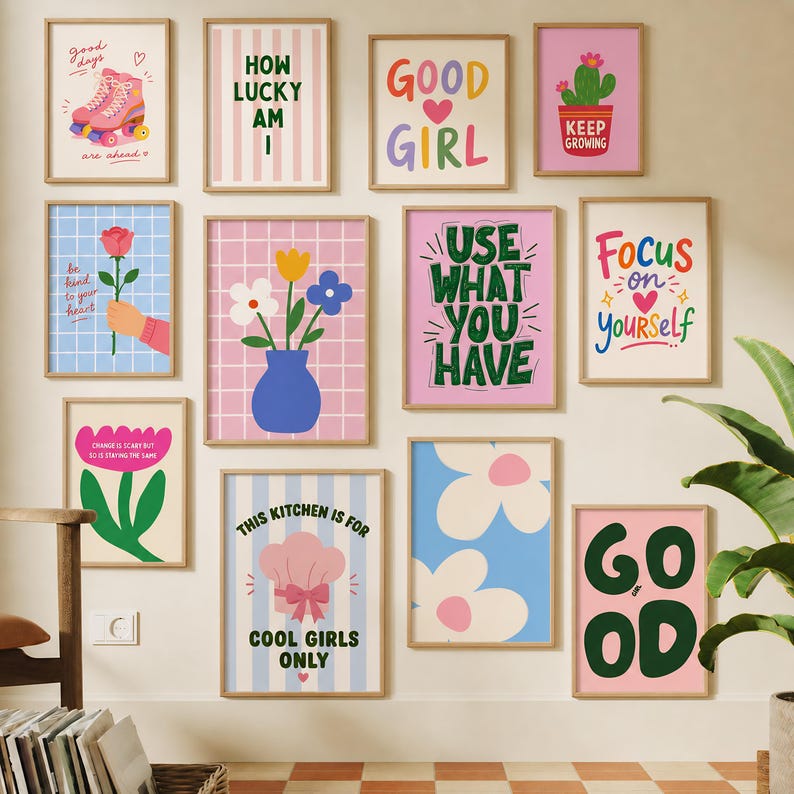 May include: A gallery wall featuring twelve rectangular framed art prints with colorful graphic designs, including illustrations of roller skates, flowers, a cactus, and various motivational text phrases like Good Girl and Focus on Yourself.