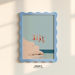 May include: A framed print featuring a light blue wavy-edged frame. The artwork depicts four figures jumping into the ocean from a white cliff. The figures are wearing swimwear in red and black. The text "PEEKY DIGITAL ART" is at the bottom.