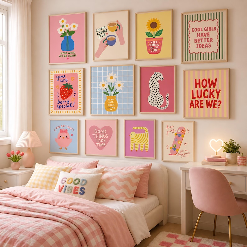 May include: A gallery wall featuring twelve framed art prints with colorful illustrations and text, including a strawberry with the text 'you are berry special', a leopard, a skateboard, and various floral designs, arranged in a grid on a wall.