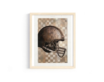 May include: Framed print of a vintage football helmet. The helmet is brown with a face mask and is set against a checkered background in shades of brown and beige. The artwork is in a light wood frame.