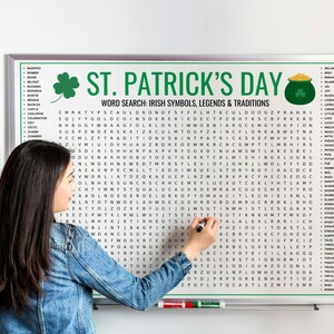 May include: A St. Patrick's Day word search puzzle on a white board with a green border. The board features the text "St. Patrick's Day" and a list of Irish-themed words. A person is using a black marker to circle words.