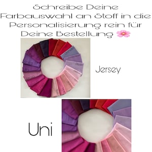 Könnte beinhalten: Eine Farbkarte mit Stoffmustern in verschiedenen Farbtönen von Rosa, Lila und Rot. Die Muster sind in einem Kreis angeordnet, wobei die Namen der einzelnen Farben darunter stehen. Der Text "Jersey" und "Uni" ist ebenfalls auf dem Bild zu sehen.