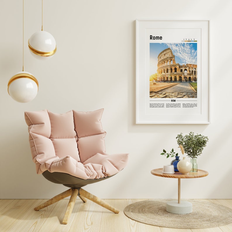 May include: A pink armchair with a white wall and a framed poster of the Colosseum in Rome, Italy. The poster has the text "Rome" and "Italy" on it. There is a small wooden table with a vase of green plants and a blue vase with a white cup on it.