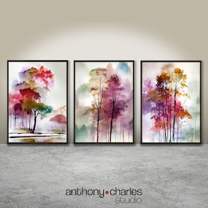 Puede incluir: Tres pinturas de acuarela enmarcadas de árboles en un entorno boscoso. Las pinturas presentan una variedad de colores, incluyendo rojo, naranja, amarillo, verde y morado. Los árboles se representan de forma estilizada, con sus ramas y hojas flotando en el viento. Las pinturas se colocan sobre un fondo de colores suaves y apagados, creando una sensación de paz y tranquilidad.