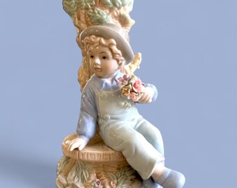 Vintage 8” porcelain figurine bud vase, boy with delicate spring flower by a tree trunk vase,