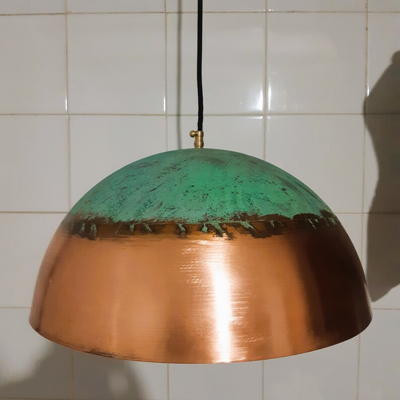 May include: A copper and green dome-shaped pendant light fixture with a black cord.