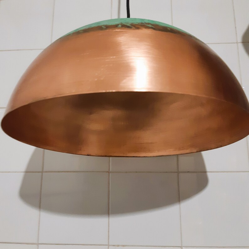 May include: A copper and green dome-shaped pendant light fixture.