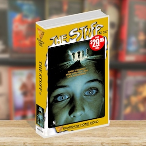 May include: A VHS tape titled The Stuff with a yellow border and white spine. The cover features a close-up of a face, silhouettes of people running, and the text Habit Forming, Mind Controlling, Life Absorbing. A red sticker shows $29.95 AUD.