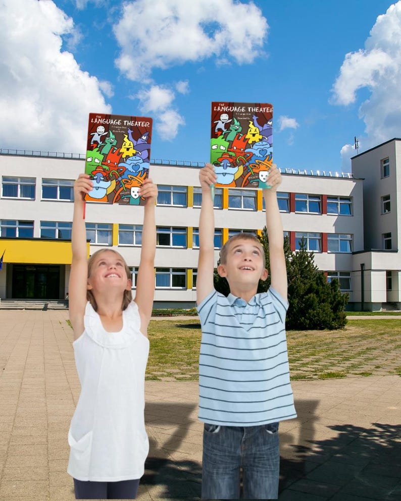 Two smiling elementary school children standing outside a school building, proudly holding The Language Theater grammar book above their heads against a bright blue sky.
