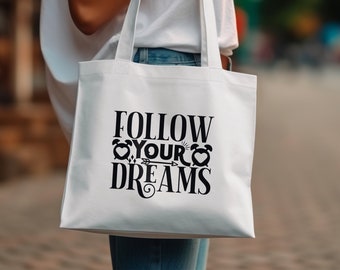 May include: White tote bag with black text that reads "Follow Your Dreams" with a heart and arrow graphic.