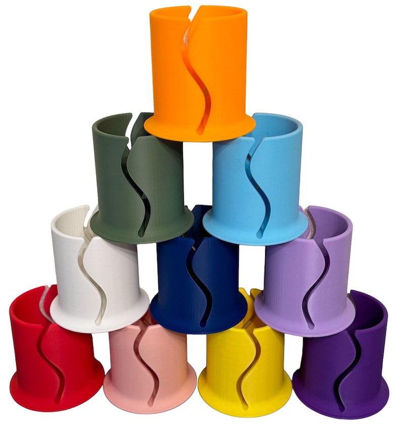 May include: A set of ten colorful plastic cup holders. The holders are stacked in a pyramid shape. The colors are orange, green, blue, white, navy blue, purple, red, pink, yellow, and purple.