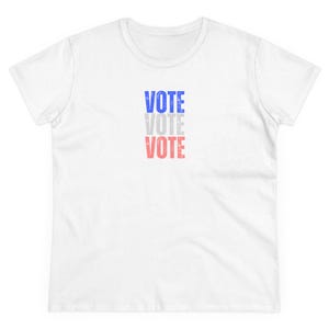 May include: White t-shirt with the word "VOTE" repeated three times in blue, gray, and red.