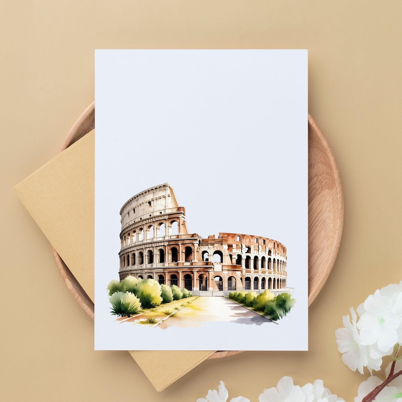 May include: A watercolor illustration of the Colosseum in Rome, Italy, on a white card. The artwork features the iconic amphitheater in shades of brown and beige, with green foliage at the base. The card is placed on a wooden plate with a beige envelope.