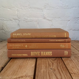 Light brown book stack, terracotta book decor, books by color, tan home decor staging books, vintage boho house decor, brown home decor