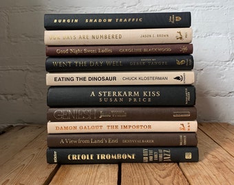 Black brown and beige decor books, stacked books, office shelf decor, coffee table books, luxury staging books, decorative styling books