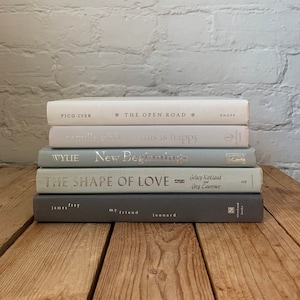 Grey blue white book stack, white and light gray book decor, decorative books, neutral grey coffee table books, grey home and office decor