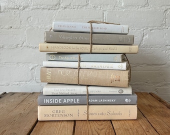 Neutral decorative book bundles in white gray and cream, curated book stacks for shelf decoration, neutral aesthetic books for table decor,
