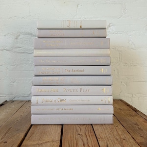 Light grey mixed styling books, elephant grey home decor, decorative coffee table books, gray interior design, real books for home staging