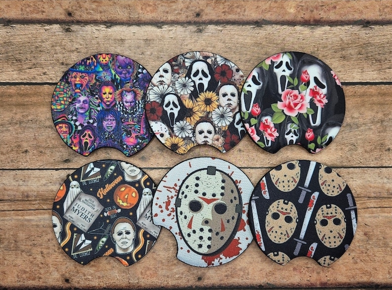 May include: Set of six car coasters with horror movie themes. Designs include a collage of horror characters, floral arrangements with ghost faces, and images of Jason Voorhees and Michael Myers.