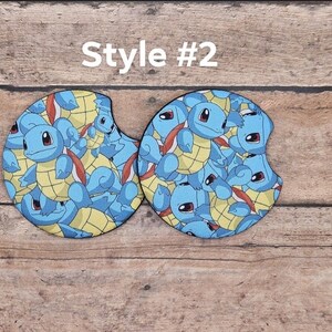May include: Two round, blue and yellow car coasters with a repeating pattern of Squirtle, a Pokemon character. The text "Style #2" is above the coasters.