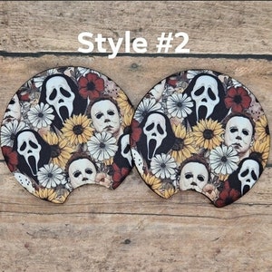 May include: Two car coasters with a floral design featuring the faces of Michael Myers and the Ghostface killer. The coasters are decorated with sunflowers, red flowers, and the text "Style #2".