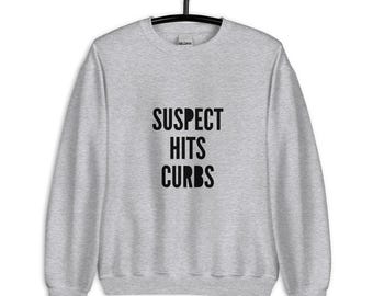Suspect Hits Curbs Sweatshirt – Funny, Relatable, and Perfectly Cozy Unisex Sweatshirt