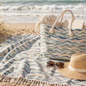 May include: A beach scene featuring a patterned tote bag, a straw hat, and sunglasses on a matching beach towel. The tote bag has rope handles and is filled with items. The towel and bag have a wave-like pattern in shades of blue, green, and tan.