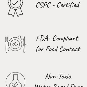 May include: Image with text stating "CSPC - Certified", "FDA-Compliant for Food Contact", and "Non-Toxic Water Based Dyes". The image includes line drawings of a badge, a plate with utensils, and a flask with a leaf.