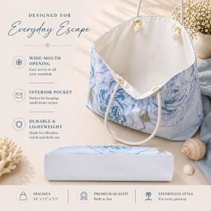 May include: A spacious tote bag with a blue floral pattern and white interior. The bag has rope handles and gold-colored metal accents. The text "DESIGNED FOR Everyday Escape" is at the top. The bag measures 24" x 13" x 5.5".