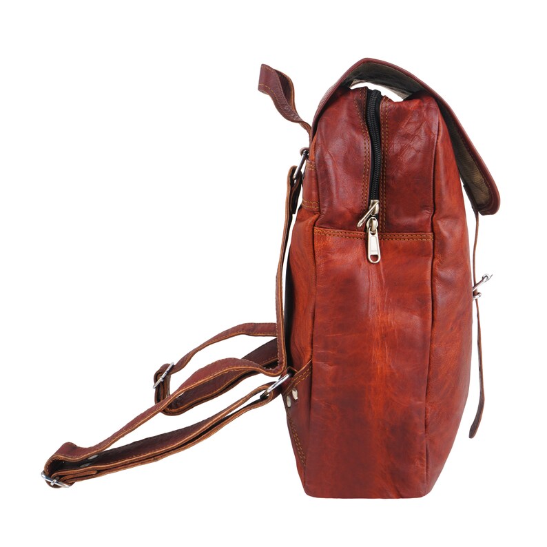 May include: A brown leather backpack with adjustable straps and a flap closure. The bag features a zippered compartment and a distressed finish, giving it a vintage look. The bag is designed for carrying items and has a classic, functional design.