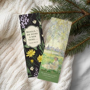 May include: Two rectangular bookmarks. One features a black background with yellow and white flowers and the text "BEHOLD, I AM DOING A NEW THING..." The other bookmark displays a landscape painting with the text "In quietness and trust is your strength."