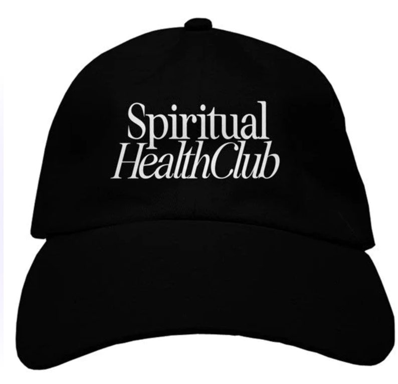 May include: A black baseball cap with white embroidered text that reads "Spiritual Health Club".
