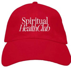 May include: A red baseball cap with the white text "Spiritual Health Club" embroidered on the front.