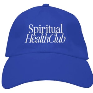 May include: A royal blue baseball cap with white embroidered text that reads "Spiritual Health Club".