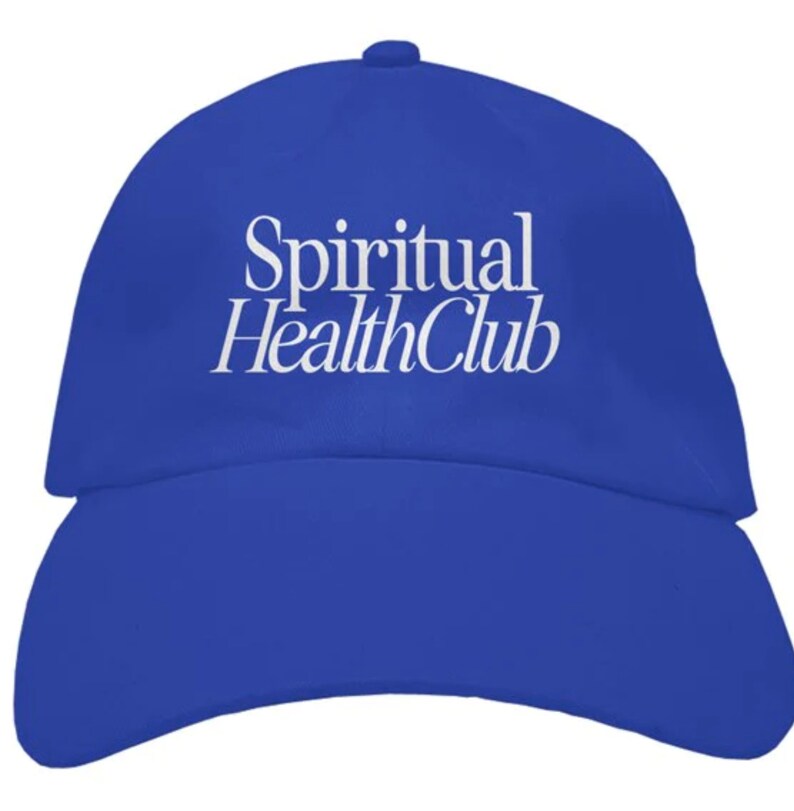 May include: A royal blue baseball cap with white embroidered text that reads "Spiritual Health Club".