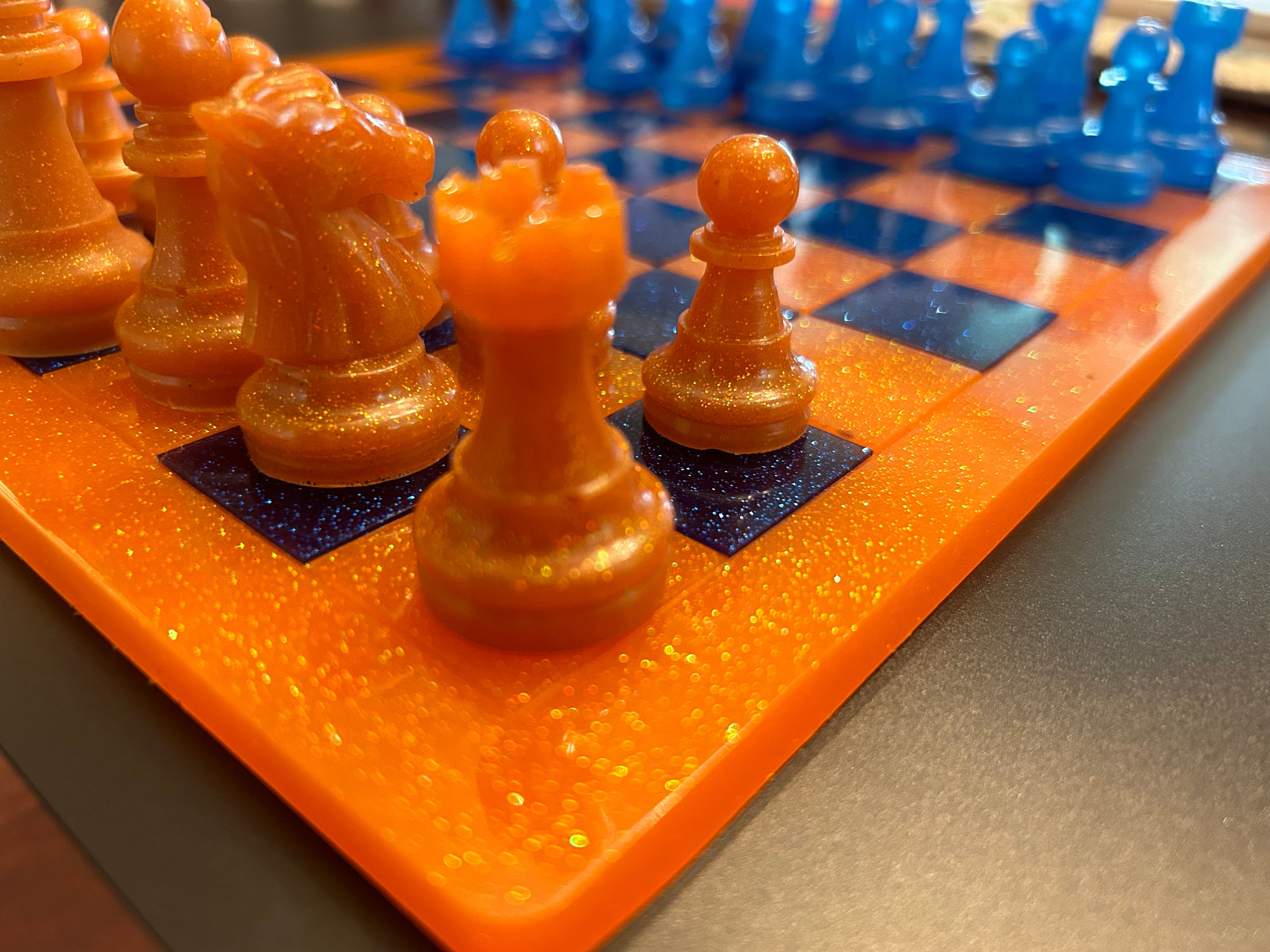 Chess Game Concept. Chess Board with Figures on Orange Background